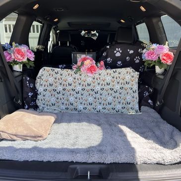 Picture of the back of an SUV that is decorated nicely for respectful deceased pet transportation.